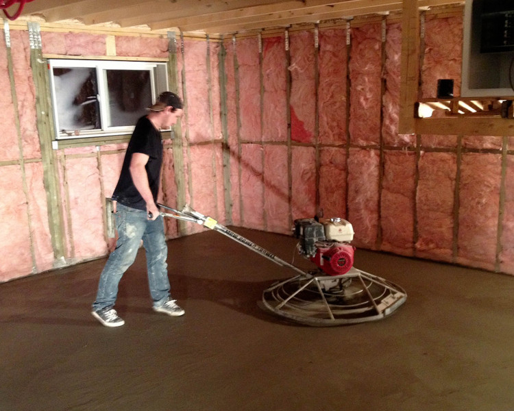 Nick finishing a basement floor.