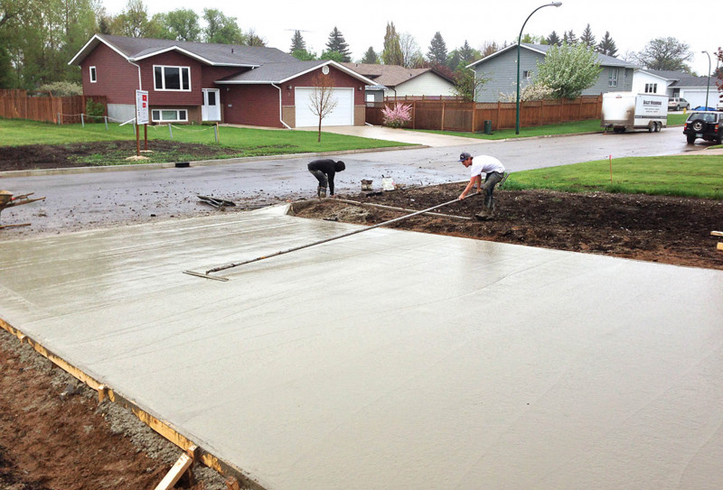 Finishing a driveway in Portage la Prairie.