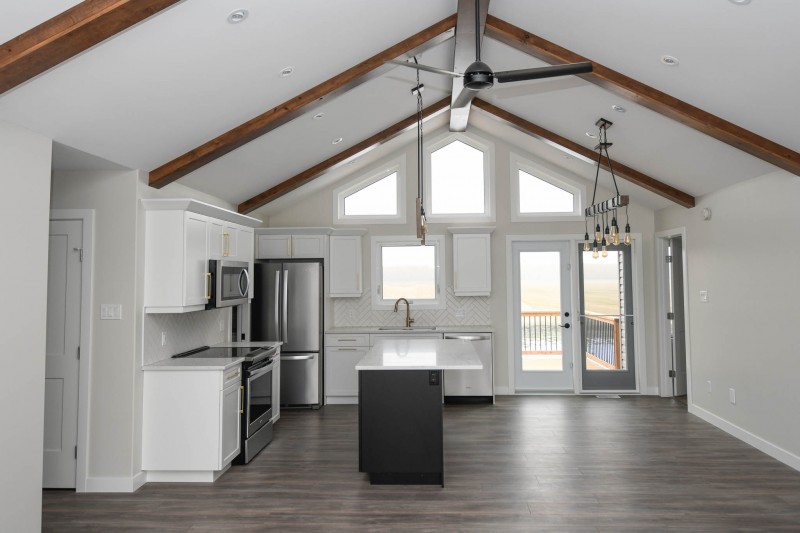 From living room looking into the kitchen dining room with vaulted ceiling through.