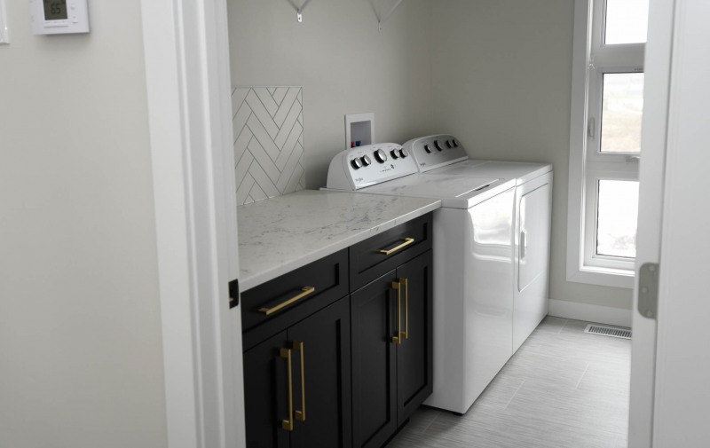 Laundry room with herringbone backsplash.