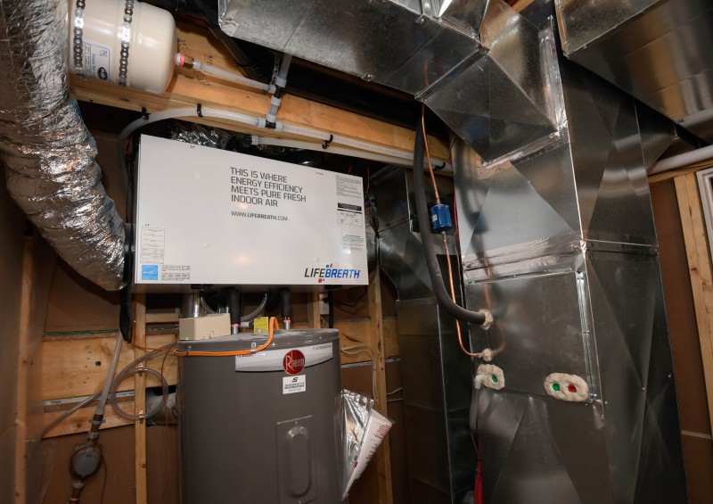 HRV furnace and hot water tank in the mechanical room.